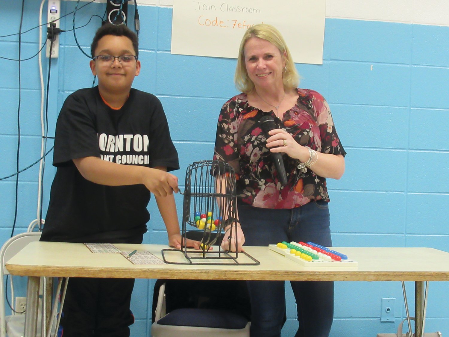 CLASSIC CALLER: Colleen Muller, a Grade 5 teacher a Thornton Elementary School turned caller for last Friday’s Bingo Night and announced numbers drawn by student Ibrahima Fall.